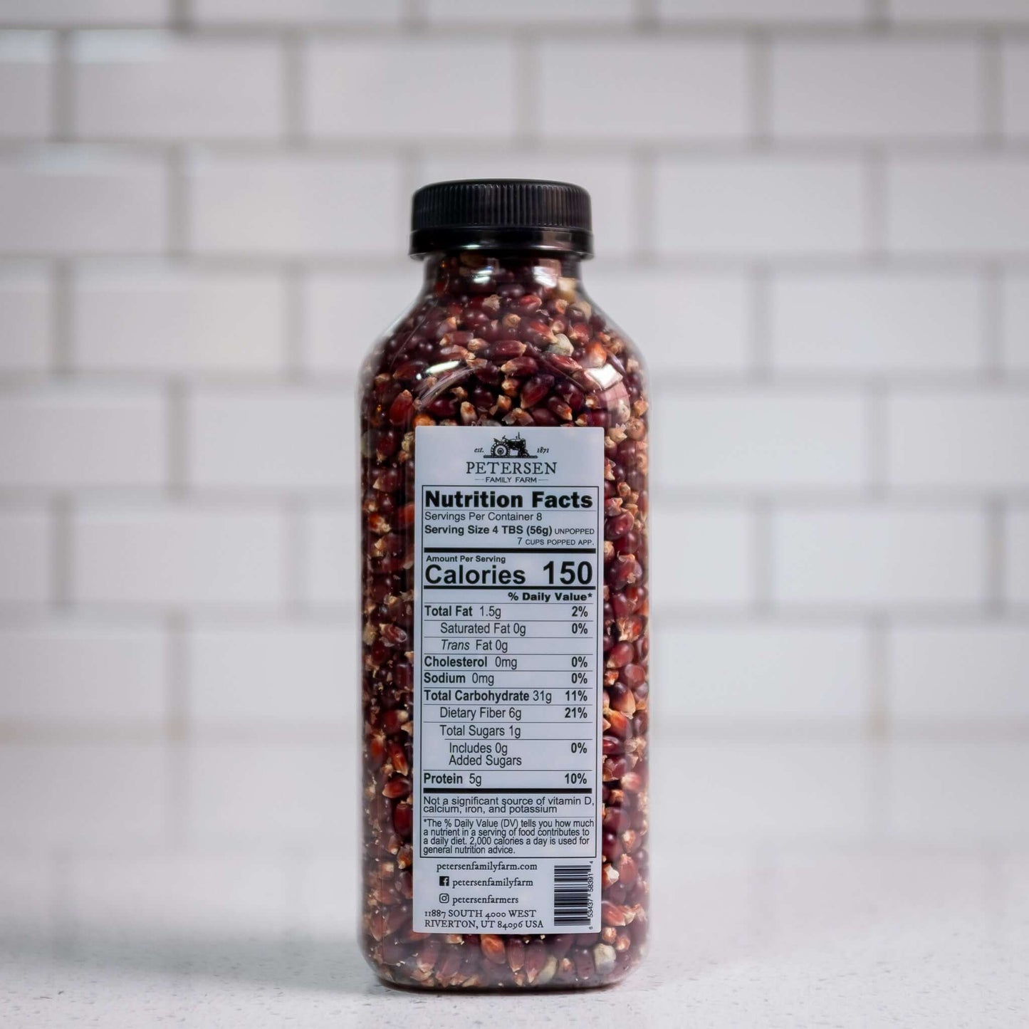 Red popcorn kernels by Petersen Family Farm. 16oz Plastic bottle, back