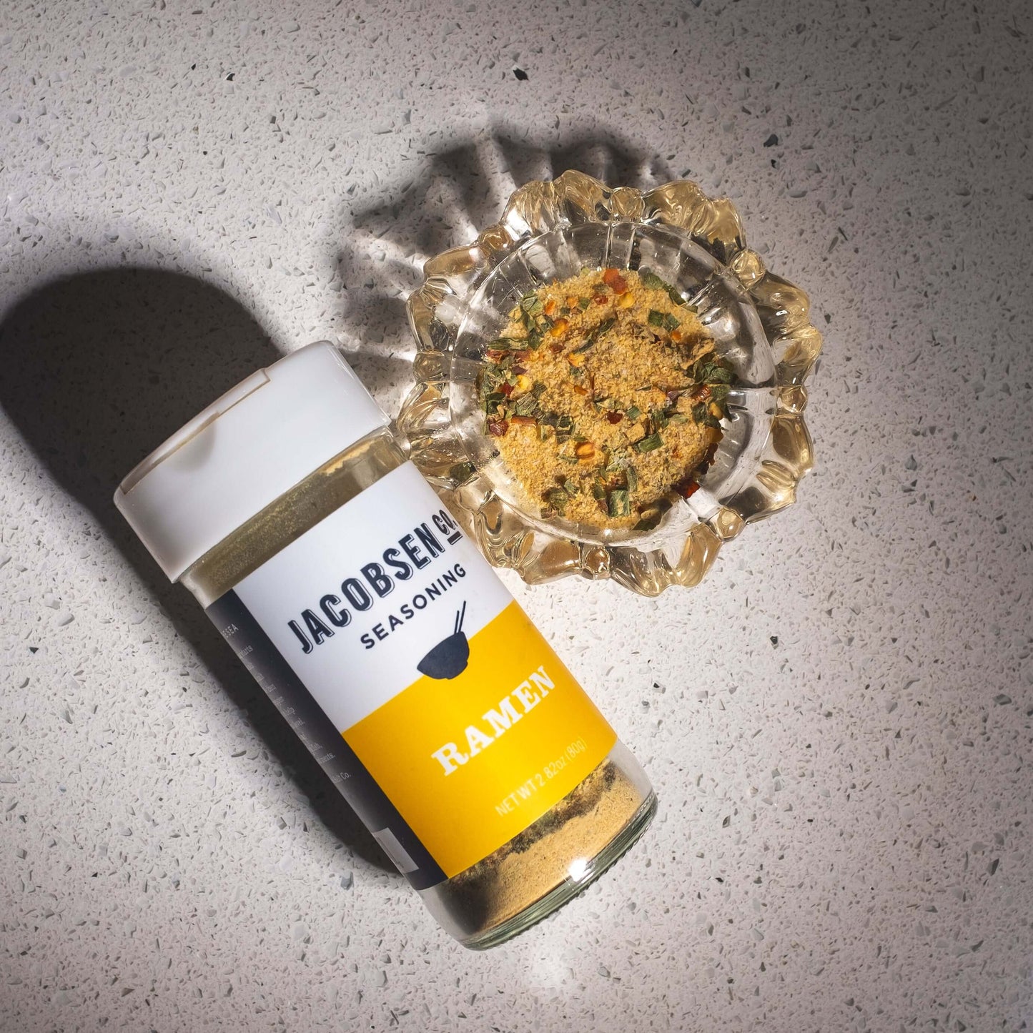 Ramen popcorn seasoning jar and loose dust to show dusty texture.