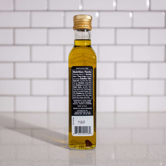 Bottle of truffle infused olive oil, back. Finishing oil for topping popcorn.