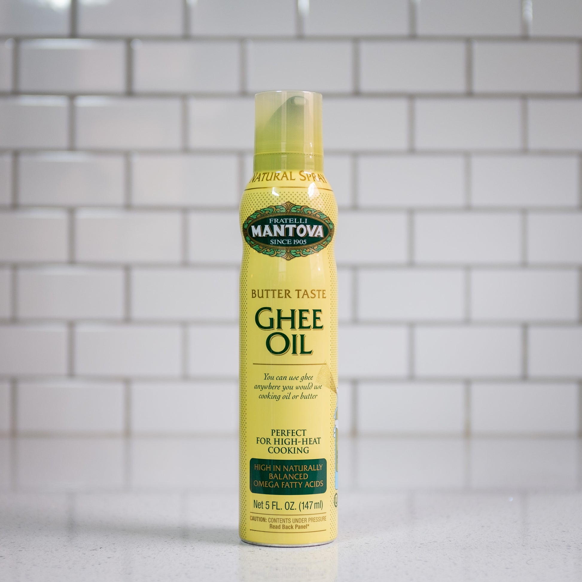 A spray bottle of ghee+olive oil.