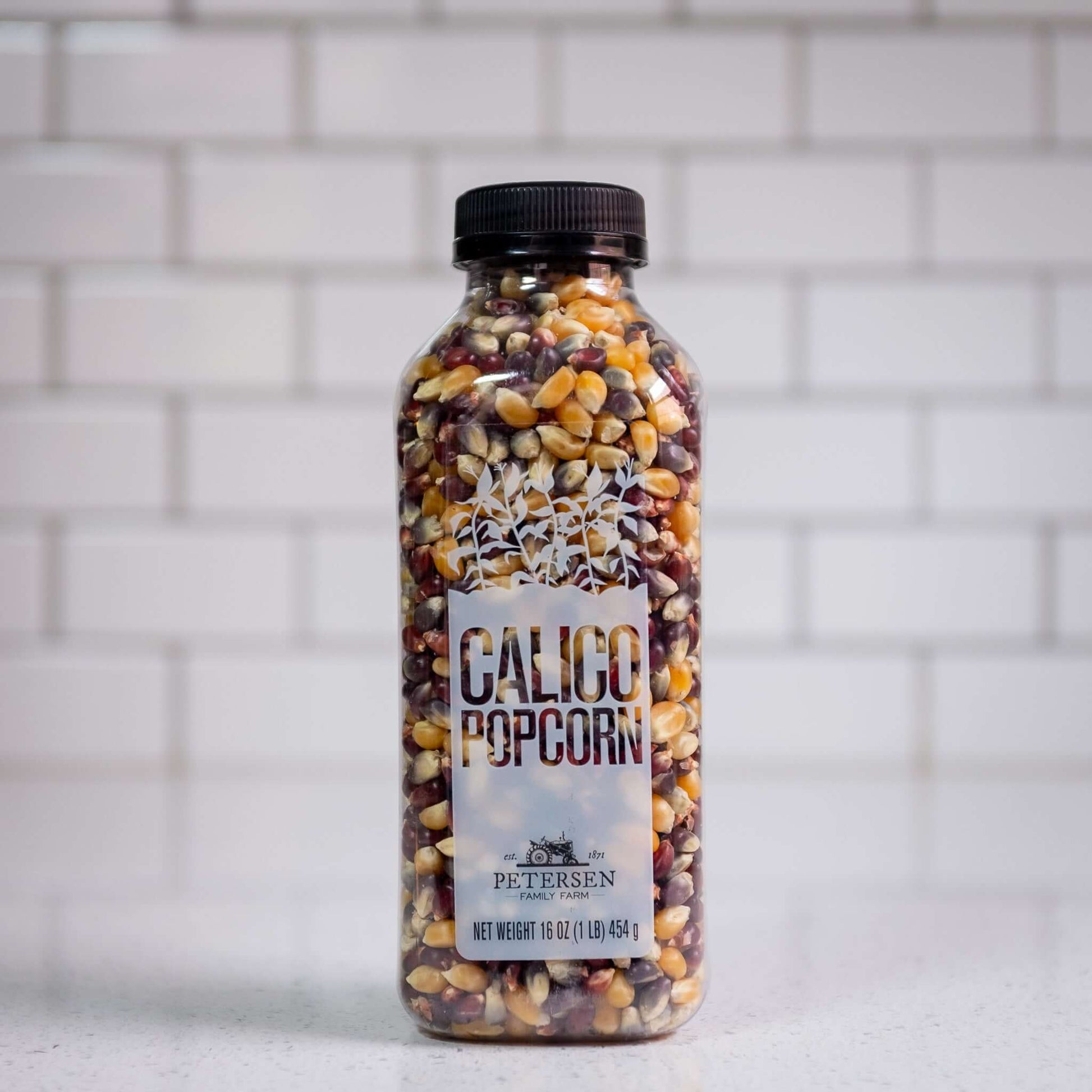 A bottle of calico popcorn kernels, front