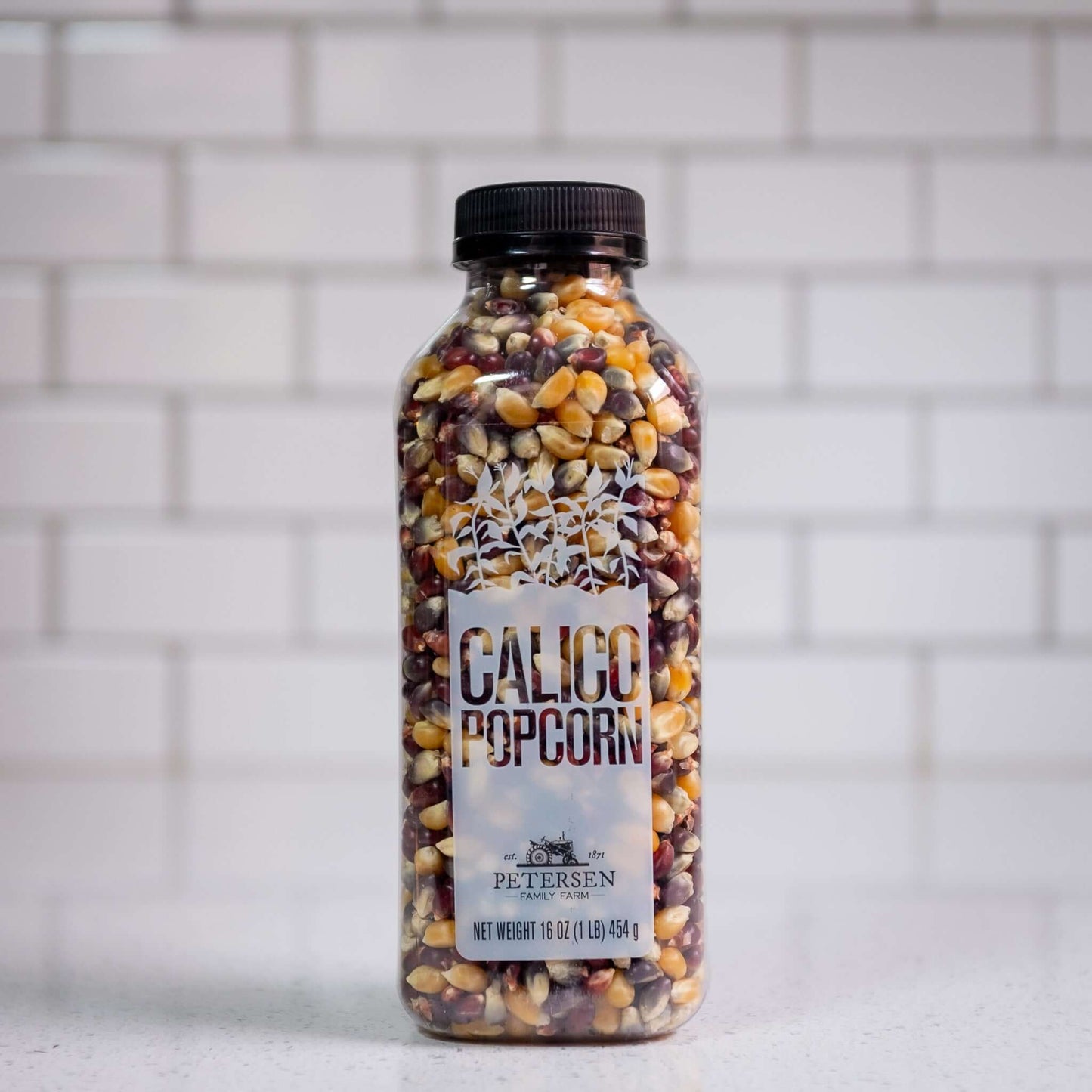 A bottle of calico popcorn kernels.