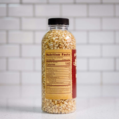 Medium white hulless popcorn kernels by Amish Country Popcorn. Side of 14oz plastic bottle