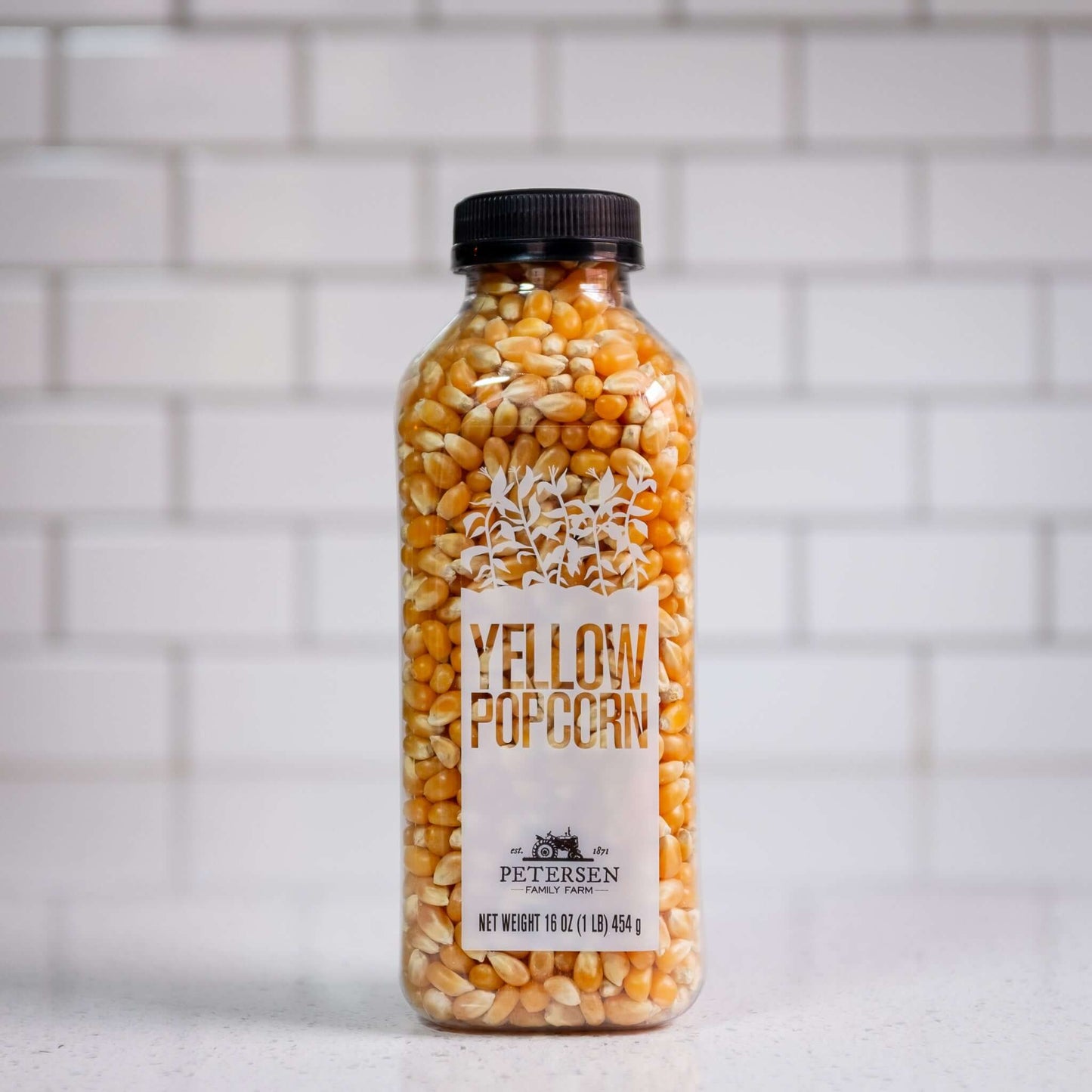 A bottle of yellow popcorn kernels.