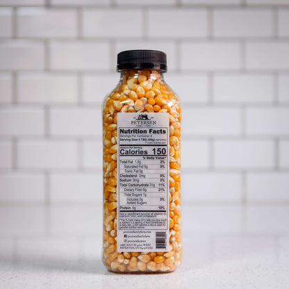 Classic yellow popcorn kernels by Petersen Family Farm. 16oz Plastic bottle, back