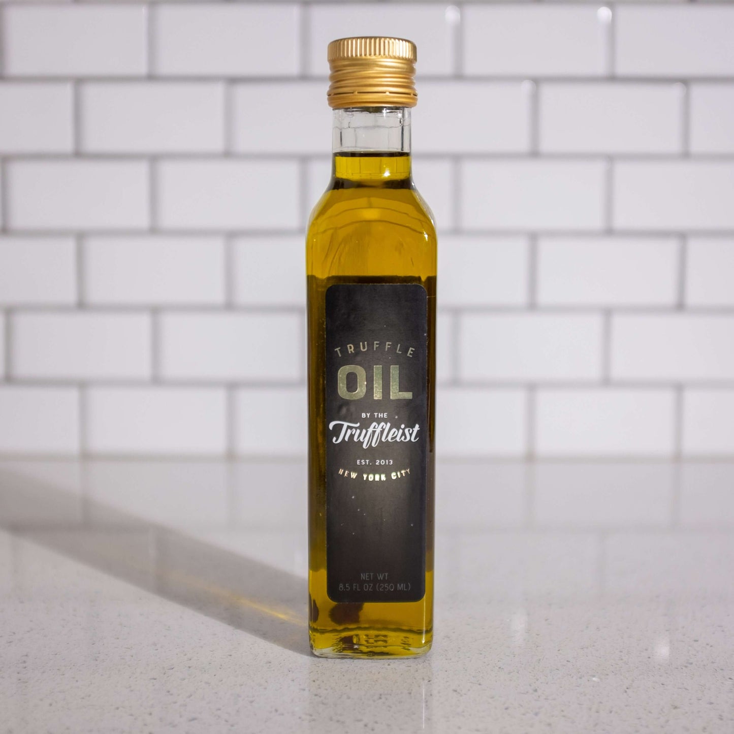 Bottle of truffle infused olive oil, front. Finishing oil for topping popcorn.