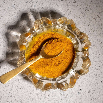 Close up of loose Turmeric popcorn dust to show dusty texture.